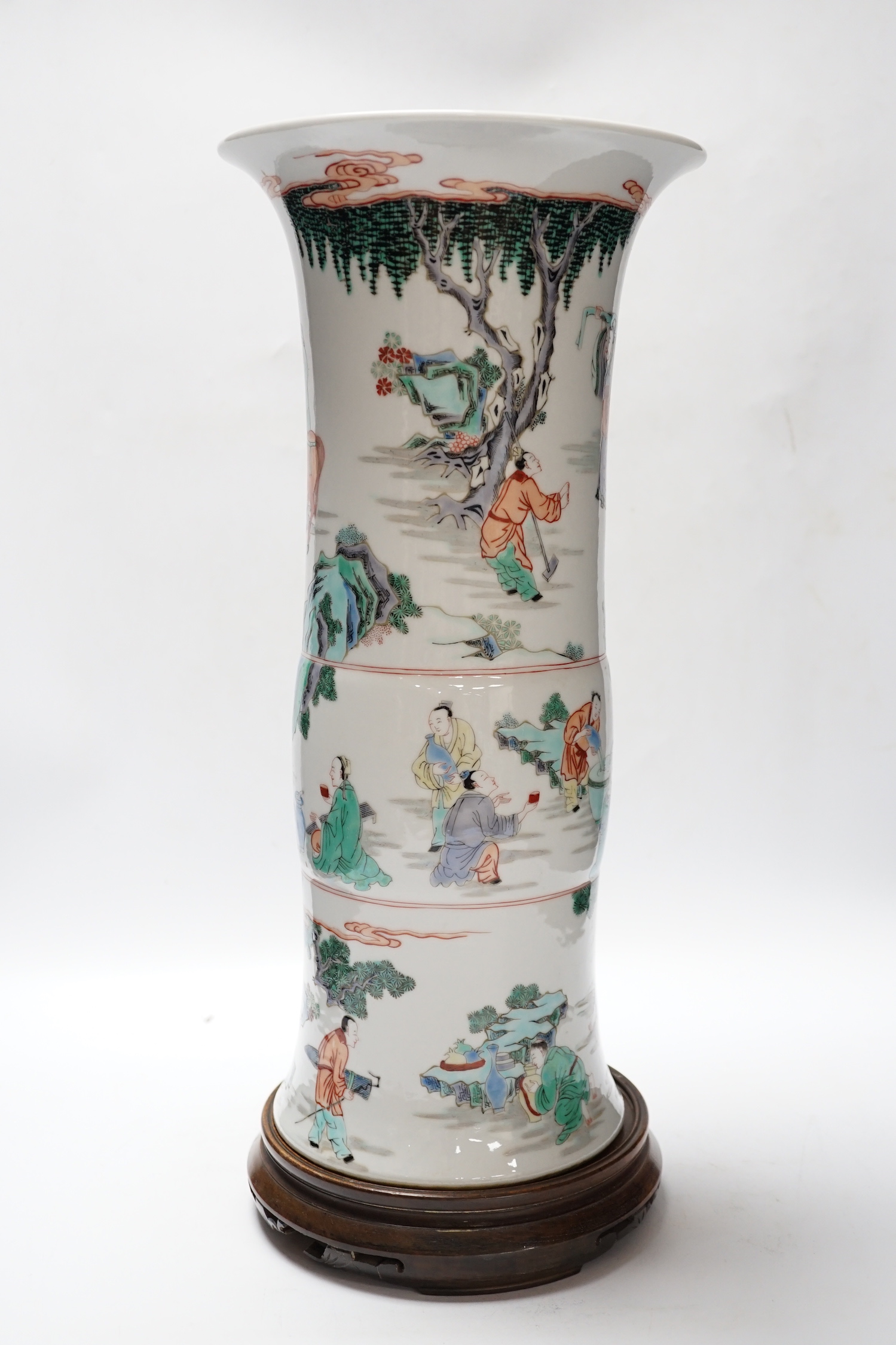 A Chinese famille verte beaker vase, Kangxi mark but later, on hardwood stand, 46cm total height